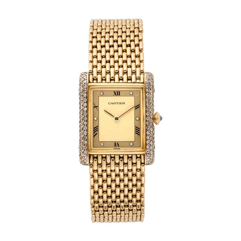 CARTIER - TANKOROLOGIO A CARICA MANUALE IN ORO GIALLO 18KT CON BRILLANTI E BRACCIALE IN ORO.