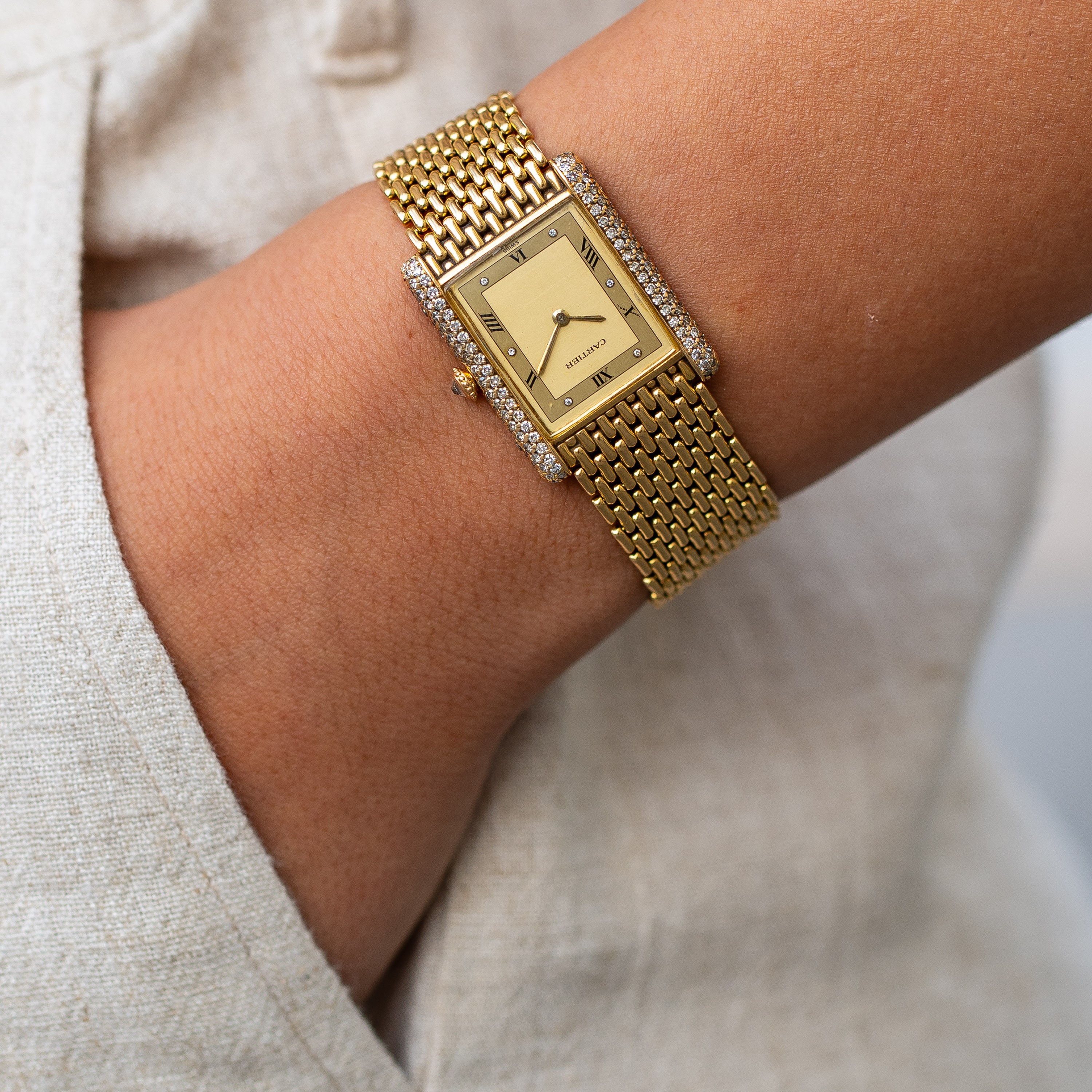 CARTIER - TANKOROLOGIO A CARICA MANUALE IN ORO GIALLO 18KT CON BRILLANTI E BRACCIALE IN ORO.