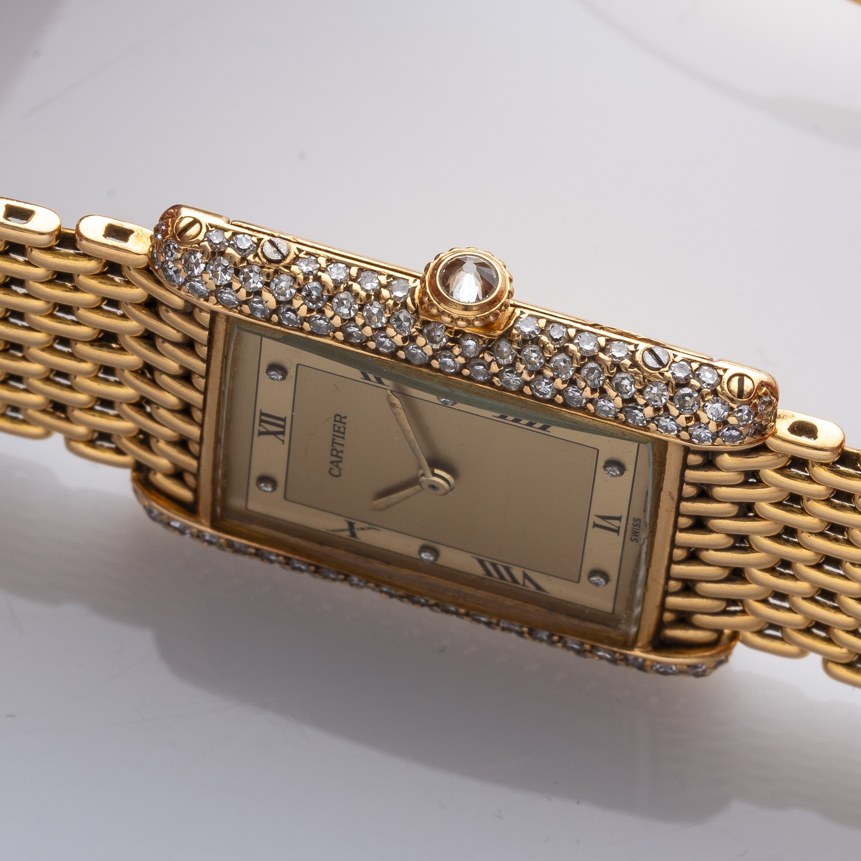 CARTIER - TANKOROLOGIO A CARICA MANUALE IN ORO GIALLO 18KT CON BRILLANTI E BRACCIALE IN ORO.
