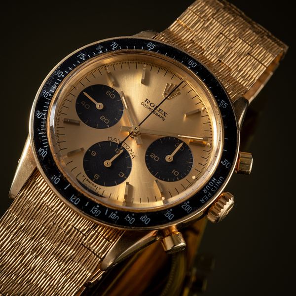 ROLEX - DAYTONA CRONOGRAFO MANUALE IN ORO GIALLO 14KT CON BRACCIALE ROLEX IN ORO 18KT A CORTECCIA.