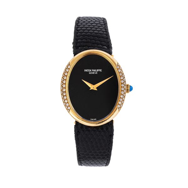 PATEK PHILIPPE - PATEK PHILIPPE - ELLIPSE LADY MANUAL WINDING WATCH IN 18KT YELLOW GOLD WITH ONYX DIAL AND BRILLIANT-CUT DIAMOND RING